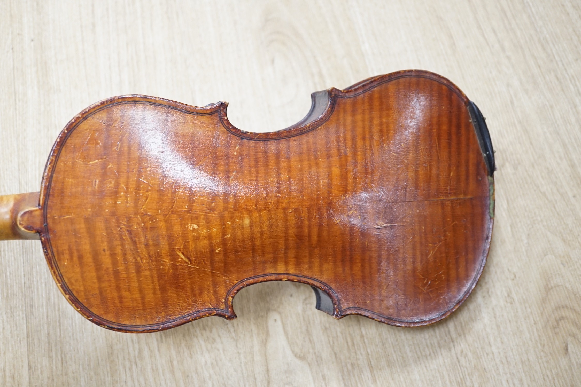 An Italian balloon back mandolin with tortoiseshell overlay, circa 1900, label for Pietro Tonelli of Napoli together with a violin, interior hand label reads ‘A.J. Newland London SW12 1939’ length of violin back excludin